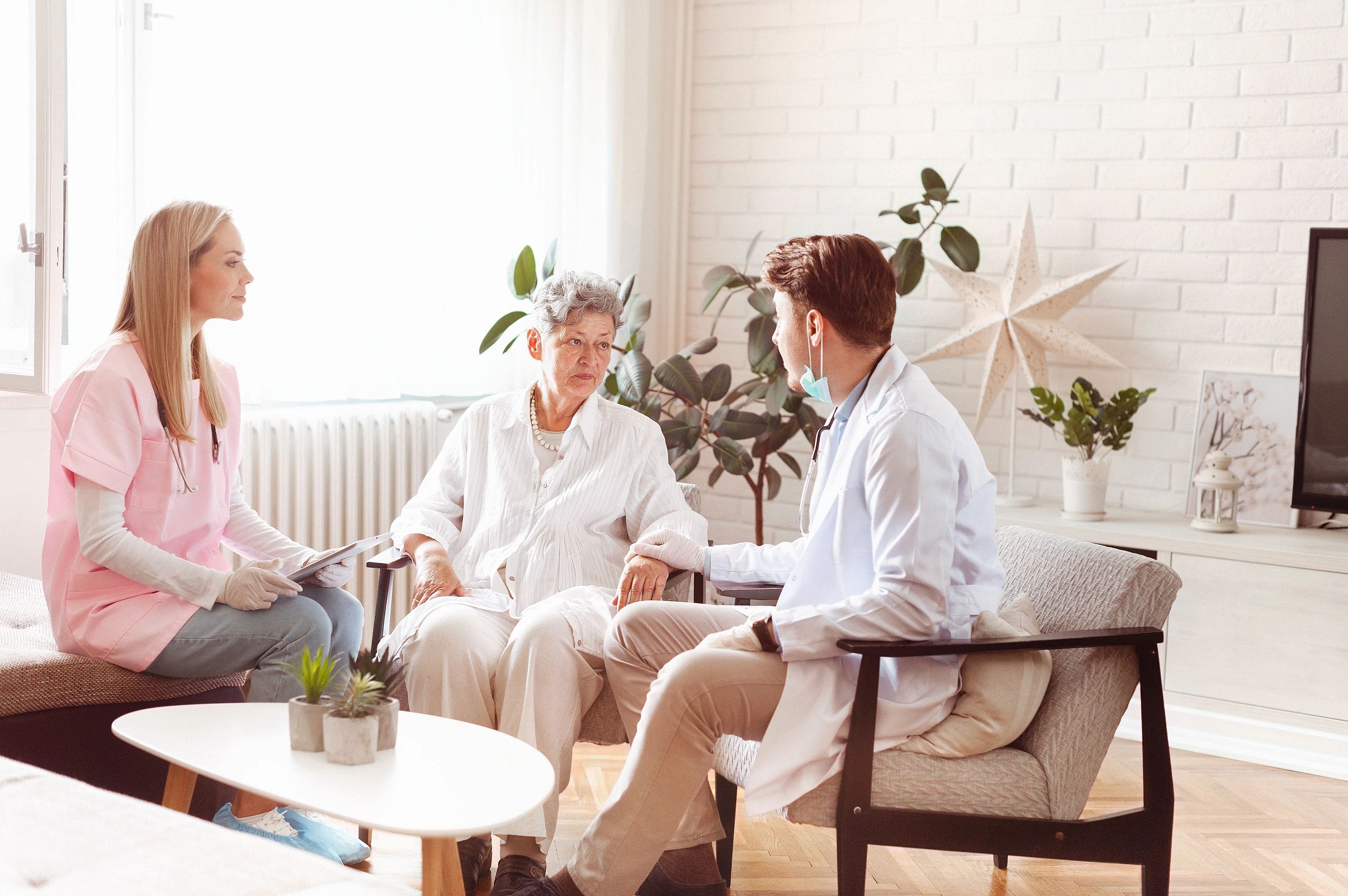 Healthcare professionals visiting an elderly woman at home